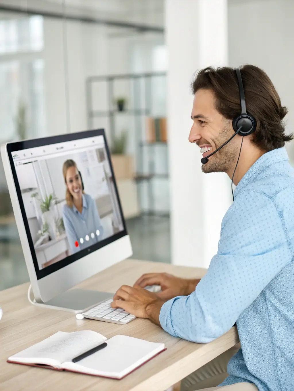 A technician providing remote support via a video call, assisting a user with a software issue on their computer.